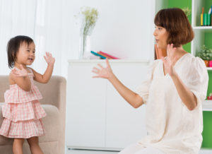 Mother and daughter clapping