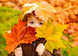 child holding leaves