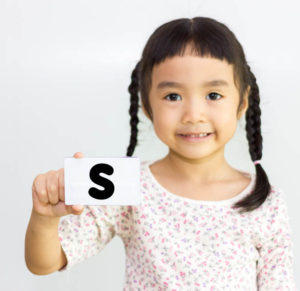 girl holding letter s