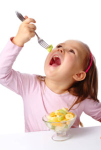 girl eating fruit salad