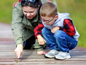 Mom and child looking at bugs