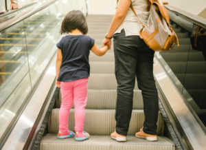 mother and child going together on escalator