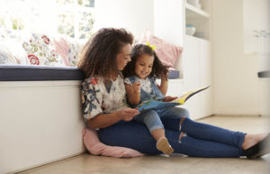 Mother reading a book with her daughter