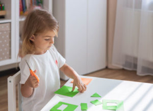 child cutting shapes