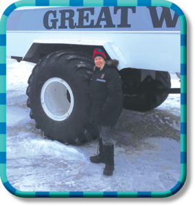 Person standing by large tire