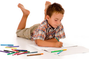 child drawing on paper