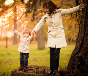 Mother and child outside in the fall.