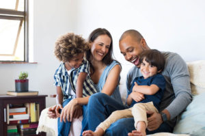 family of four laughing together