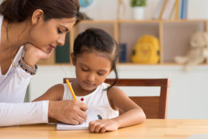 Mother and child writing