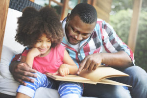 Father and daughter reading a book