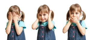 Girl doing hear no evil, see no evil and speak no evil