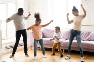 Family dancing in living room