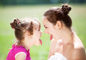 Mother and daughter making funny faces