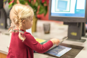 girl checking out books at the Library