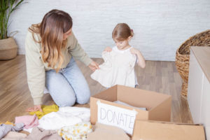 Mother and daughter are sorting  clothes to donate